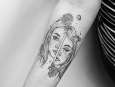 a woman's face with flowers and planets on her arm, in black and white