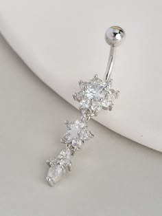 a pair of clear crystal navel piercings with white stones on the top and bottom