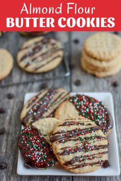 cookies with chocolate drizzle and sprinkles are on a white plate