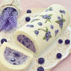 a cake with blueberries and lavenders on it