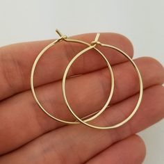 Lovely 18 gauge, Solid 14k Gold Hoop Earrings1.25" size photographed; 2" size shown in videoMETAL: Solid 14k Yellow GoldWIRE GAUGE/DIAMETER: 18 gauge (1.0mm) wire - Slightly thicker than standard ear wire thicknessEARRING DIAMETER SIZE: Approximately 3/4", 1", 1.25" (Pictured), 1.5", 1.75", 2", 2.25", 2.5" -OR- 3" diameter.  Choose the size that is right for you!NOTE: Please review all listing photos, ArisDesignsJewelry Policies and FAQ sections prior to purchase.Find the full selection of 14k, Real Gold Hoop Earrings, Saint Helens, 14k Gold Hoop Earrings, Christmas Gifts For Wife, Hammered Earrings, Sterling Silver Hoop Earrings, Gold Wire, Gift For Wife, Sterling Silver Hoops