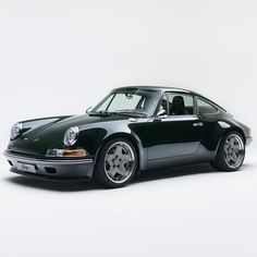 a black porsche parked in front of a white background