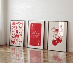 three framed art pieces on the floor in front of a window