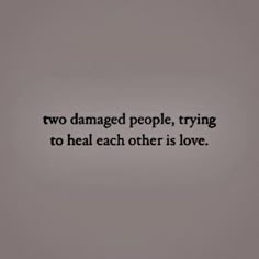 two damaged people, trying to heal each other is love text on grey background with black and white photo