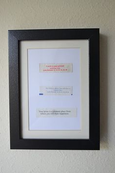 a black frame with a white border hanging on a wall