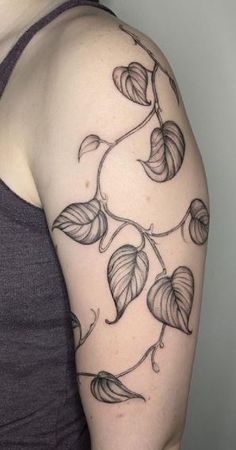 a woman's arm with leaves on it