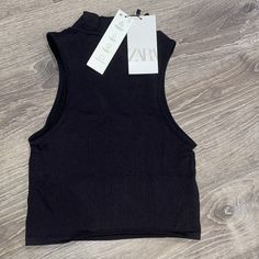 Nwt Zara High Neck Black Top Sleeveless Ribbed, Stretchy Material Never Worn Fitted Black Ribbed Vest, Black Ribbed Sleeveless Vest, Black Sleeveless Ribbed Vest, Black Stretch Seamless Vest, Black Fitted Seamless Vest, Zara Fitted Tank Vest, Zara Fitted Crop Tank Top, Zara Black Stretch Crop Top, Zara Stretch Solid Color Tank Top