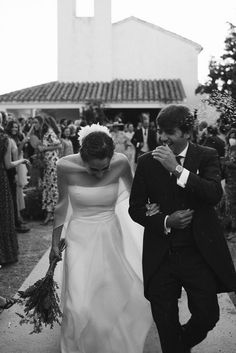 a bride and groom walking down the aisle