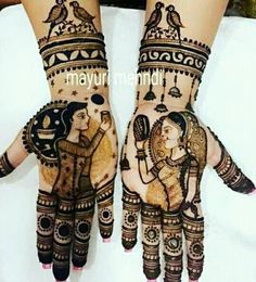 two hands decorated with henna designs and birds on them, one is holding an elephant