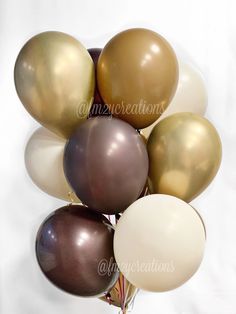 a bunch of balloons that are brown and white with some gold on the top one