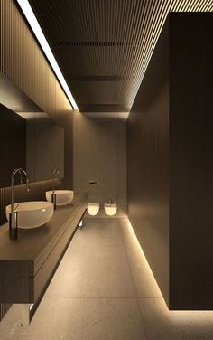 an image of a bathroom with lights on the ceiling and two sinks in the middle