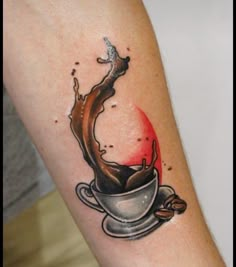 a tattoo on the arm of a woman with coffee