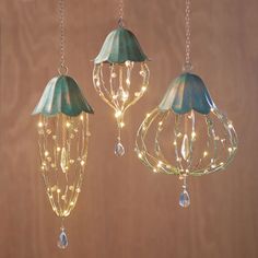 two hanging lights that have been made to look like chandeliers