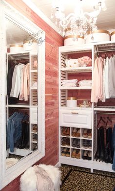 an open closet with clothes and shoes in it, next to a chandelier