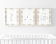 two framed pictures hang on the wall above a crib in a white nursery room