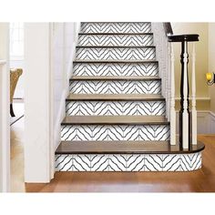 the stairs are decorated with black and white wallpaper