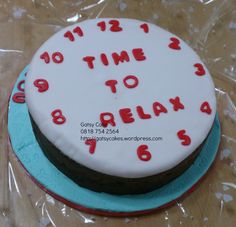 there is a cake that says time to relax on the top and red numbers on the bottom