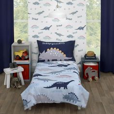 a child's bedroom with dinosaur wallpaper and blue curtains