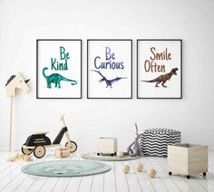 three children's posters on the wall in a white room with toys and decor