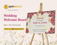 a wedding welcome board with flowers on it