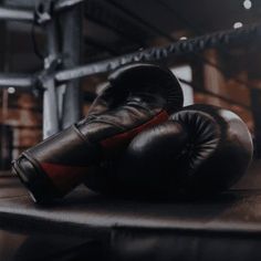 two boxing gloves sitting on top of a wooden table