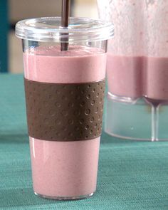 a pink smoothie in a plastic cup with a straw