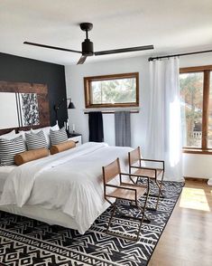 a bedroom with a bed, chair and rug in it's centerpieces