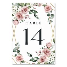 a table number card with pink roses and greenery