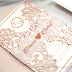 a wedding card with a heart on the front and side, sitting on top of a table