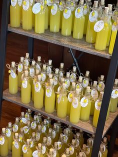 several shelves filled with yellow liquid bottles and labels on the top one is labeled lemonade