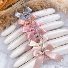 four pairs of hair clips with bows on top of each one, sitting next to a pile of fur