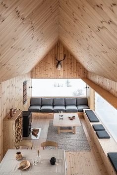 a living room filled with furniture and wooden walls