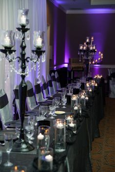 a long table is set up with candles and place settings for an event or party