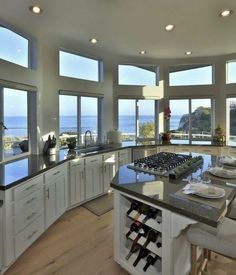 a large kitchen with lots of windows overlooking the ocean