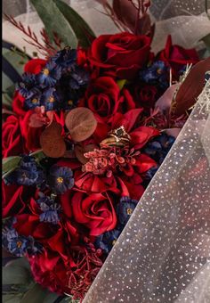 a bridal bouquet with red and blue flowers