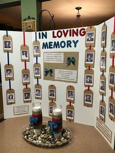 a memorial display with two jars and pictures on the front, sitting on a table