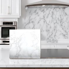 a kitchen with marble counter tops and stainless steel oven hoods, range hood, and microwave