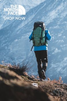 a person with a backpack walking up a hill