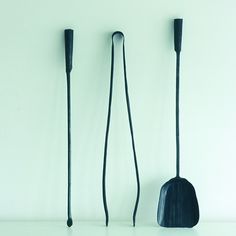 three different sized shovels and two long black handles