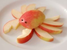 an apple shaped like a crab on a white plate