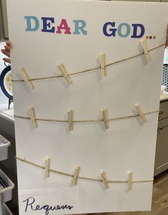 a sign with clothes pins attached to it that says dear god