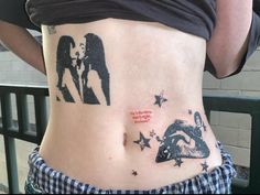 a woman's stomach with some tattoos on it and an image of two people