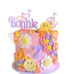 a pink cake with yellow and purple decorations on it's top that says bonnie