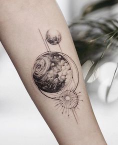 a woman's arm with a tattoo on it and an image of the earth