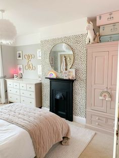 a bedroom decorated in pink and white with a cheetah print wallpaper on the walls