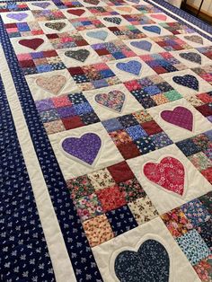 a quilted table runner with hearts on it