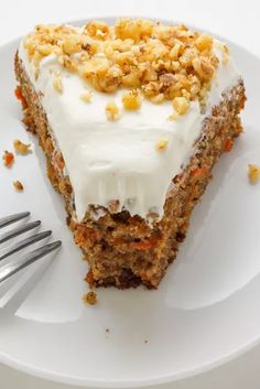 a piece of carrot cake on a plate with a fork