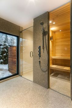 a bathroom with a walk in shower next to a window