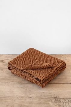 a brown blanket folded on top of a wooden table