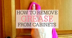 a hand holding a pink towel in front of a kitchen cabinet with the words how to remove grease from cabinets